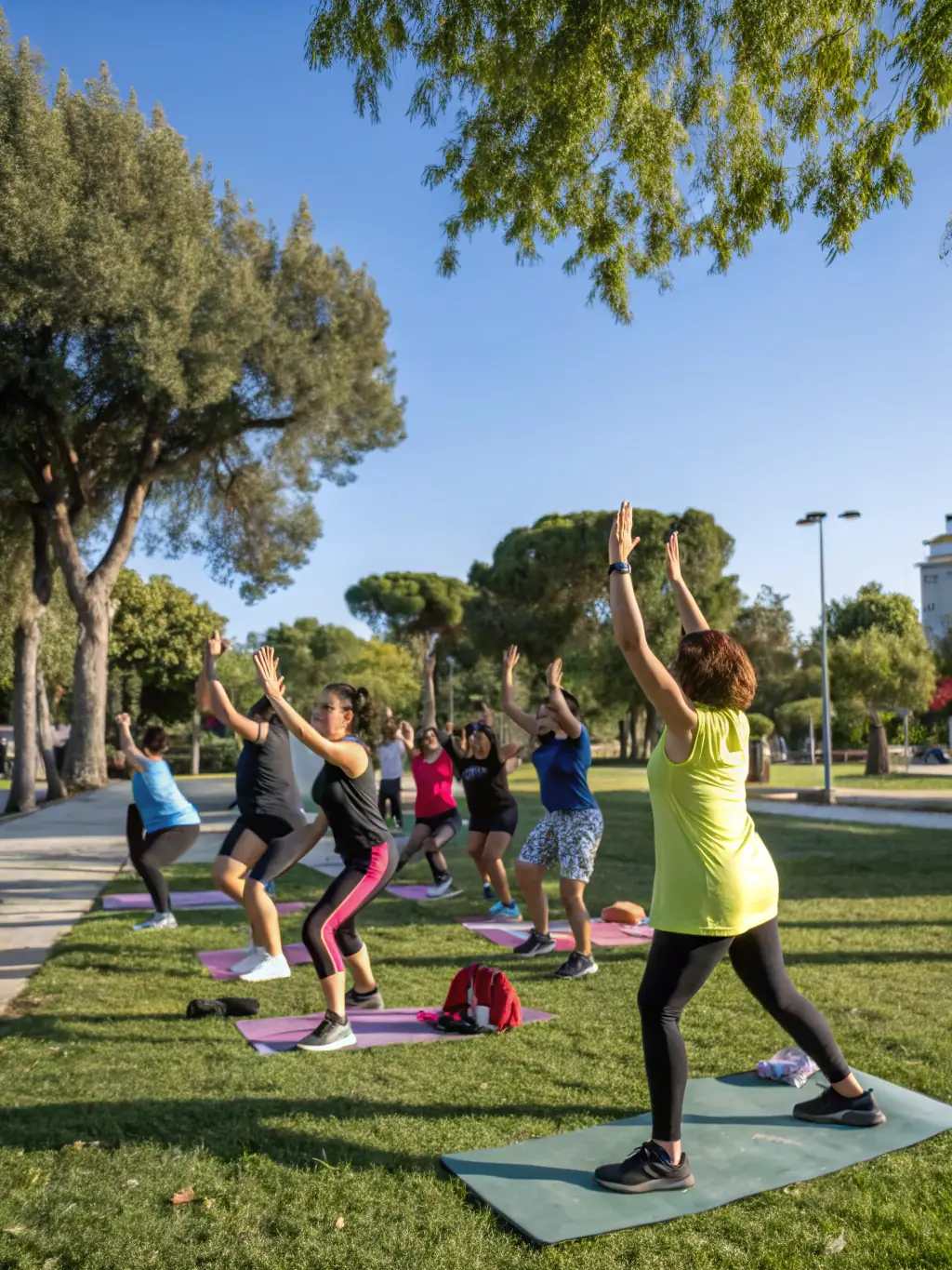 A diverse group of adults laughing and chatting after a GV fitness class, showcasing the social benefits and community bonding aspect.